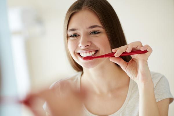 woman brushing her teeth